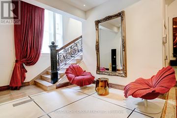 Toronto (Church-Yonge Corridor) condo for rent - A living room with a red chair and a mirror.
