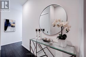 Toronto (Church-Yonge Corridor) condo for rent - A white room with a glass table and a round mirror.