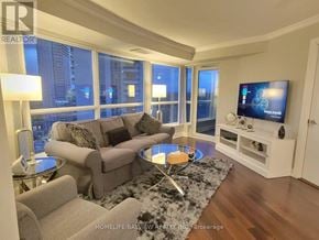 Toronto (Agincourt South-Malvern West) condo for rent - A living room with a couch, a coffee table, and a television.