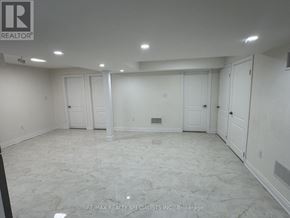Brampton (Toronto Gore Rural Estate) apartment for rent - A spacious room with marble flooring and white walls, ready for a new tenant.