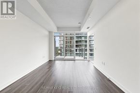 Toronto (Humber Heights) condo for rent - A spacious room with wooden flooring and a large glass door leading to a balcony.