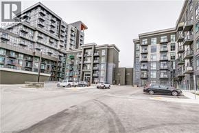 Waterdown condo for rent - A parking lot in front of a multi-story residential building.