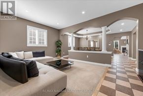 Niagara-On-The-Lake (Glendale) apartment for rent - A living room with a sofa, a coffee table, and a chandelier.
