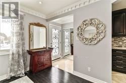 Toronto (Wexford-Maryvale) apartment for rent - A large mirror is on the wall above a wooden console table.