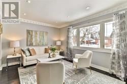 Toronto (Wexford-Maryvale) apartment for rent - A living room with a couch, chair, and a painting on the wall.