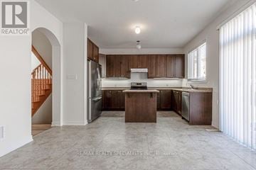 Milton (Sc Scott) apartment for rent - A spacious kitchen with dark wood cabinets and a central island.