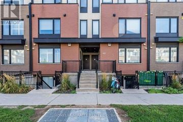 Toronto (Downsview-Roding-Cfb) townhouse for rent - A brick building with a black gate in front.