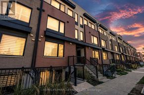 Toronto (Downsview-Roding-Cfb) townhouse for rent - A row of townhouses with a bicycle leaning against the fence.