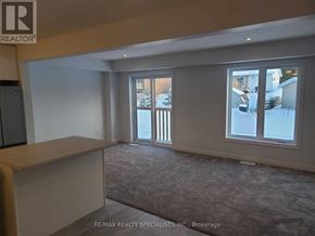 Grey Highlands townhouse for rent - A room with a carpeted floor and a large window.