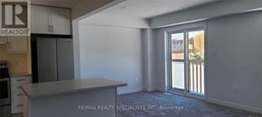 Grey Highlands townhouse for rent - A kitchen area with a counter and cabinets in a room with a sliding glass door.