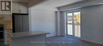 Grey Highlands townhouse for rent - A kitchen area with a counter and cabinets in a room with a sliding glass door.