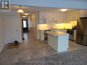 Grey Highlands townhouse for rent - A kitchen with white cabinets and a large island.