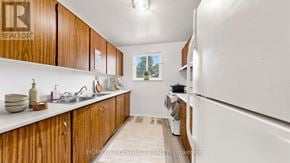 Oshawa (Lakeview) apartment for rent - A kitchen with wooden cabinets and a white refrigerator.