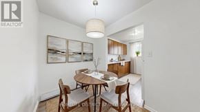 Oshawa (Lakeview) apartment for rent - A dining room with a table set for two and a painting on the wall.