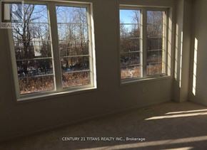 Oshawa (Windfields) apartment for rent - Two windows in a room with a view of trees and a building outside.