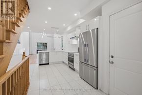 Niagara-On-The-Lake (Town) townhouse for rent - A modern kitchen with stainless steel appliances and white cabinetry.