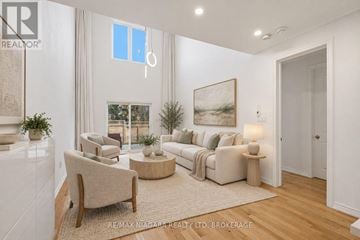 Niagara-On-The-Lake (Town) townhouse for rent - A living room with a couch, chair, and a painting on the wall.