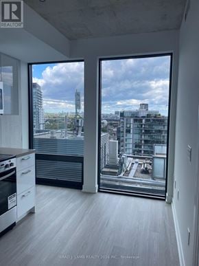 Toronto (Moss Park) condo for rent - A modern kitchen with a view of the cityscape outside the window.