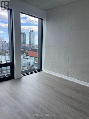 Toronto (Moss Park) condo for rent - A room with a view of the city through a large window.