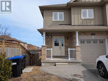 Innisfil (Alcona) townhouse for rent - A house with a brown roof and a white garage door.