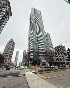 Mississauga (City Centre) condo for rent - A tall building with many windows is under construction in a city.