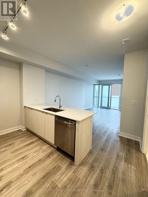 Mississauga (City Centre) condo for rent - A kitchen with a sink and cabinets is empty and ready for staging.