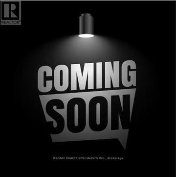 Hamilton townhouse for rent - A sign that says "COMING SOON" is lit up in a dark room.
