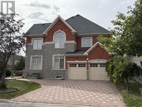 Vaughan (Patterson) apartment for rent - A brick house with a garage and a driveway.