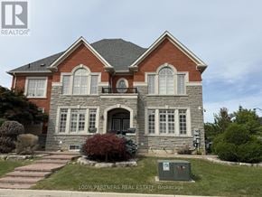 Vaughan (Patterson) apartment for rent - A house with a stone foundation and a brick exterior with a large front yard.