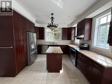 Vaughan (Patterson) apartment for rent - A kitchen with brown cabinets and a central island.