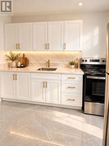 Toronto (Stonegate-Queensway) condo for rent - A modern kitchen with white cabinets and a marble countertop.