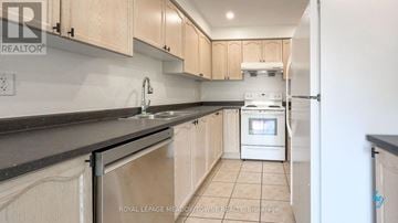 Mississauga (Churchill Meadows) townhouse for rent - A kitchen with wooden cabinets and a white oven.