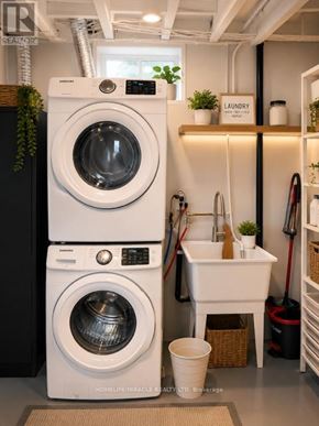 London North (North C) apartment for rent - A white washing machine and dryer stacked on top of each other in a laundry room.
