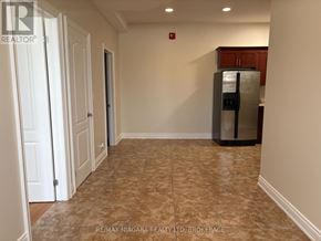 Fort Erie (Ridgeway) apartment for rent - A kitchen area with a refrigerator, cabinets, and a tiled floor.
