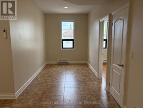 Fort Erie (Ridgeway) apartment for rent - A room with a window and a door is shown in this image.