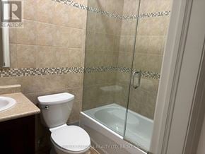 Fort Erie (Ridgeway) apartment for rent - A bathroom with a toilet, sink, and shower.