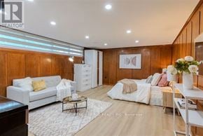 Toronto (Bathurst Manor) apartment for rent - A well-lit, modern living room with a white sofa, a coffee table, and a bed with white bedding.