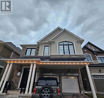 Caledon apartment for rent - A house with a realtor sign in front.
