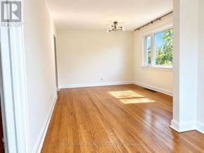 Toronto (Downsview-Roding-Cfb) apartment for rent - A room with wooden flooring and a window letting in sunlight.