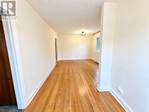 Toronto (Downsview-Roding-Cfb) apartment for rent - A hallway with wooden floors and white walls.