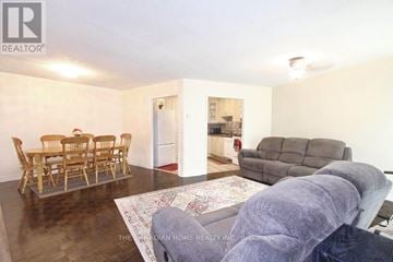 Mississauga (Malton) condo for rent - A living room with a dining table and chairs.