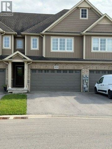 Niagara Falls (Oldfield) townhouse for rent - A white van is parked in front of a grey garage door.