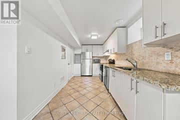 Toronto (Dufferin Grove) apartment for rent - A kitchen with white cabinets and a tiled floor.