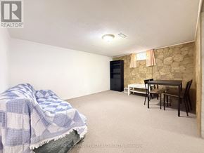 Richmond Hill (Crosby) apartment for rent - A room with a bed covered in a blanket, a chair, and a dining table.