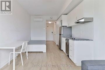 Oshawa (Samac) condo for rent - A white kitchen with a table and chairs in a small room.