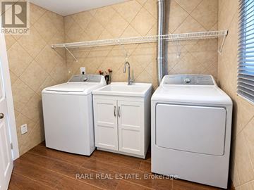 Toronto (Black Creek) apartment for rent - A small laundry room with a washer and dryer in it.