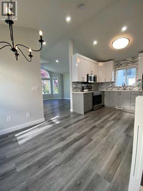 Calgary apartment for rent - A well-lit kitchen with a grey floor and white walls.
