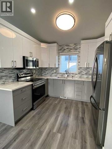 Calgary apartment for rent - A modern kitchen with a refrigerator on the right side.