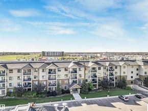 Edmonton apartment for rent - A large apartment complex with multiple buildings and a parking lot in the foreground.