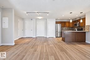 Edmonton apartment for rent - A spacious kitchen with wooden floors and a modern design.